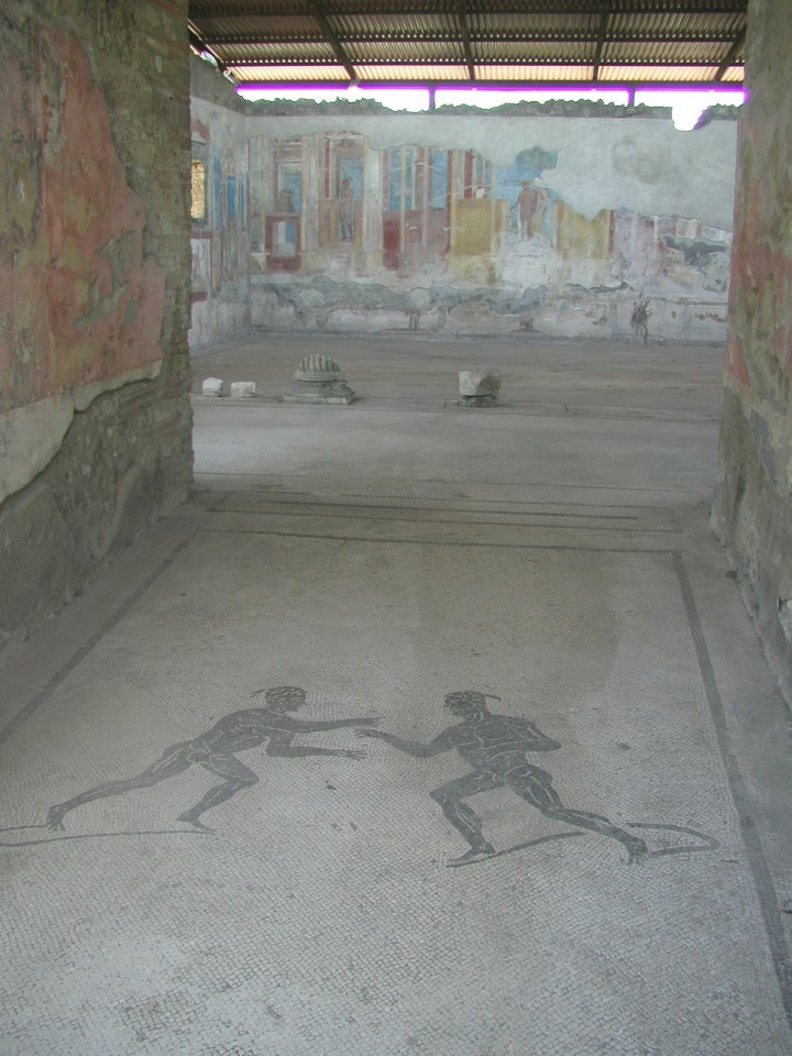 JPEG image - Pompei : The entrance to one of the many rich persons house. Lots of well preserved mosaics on floors. Lots of wall decorations still amazingly bright after all this time. ...