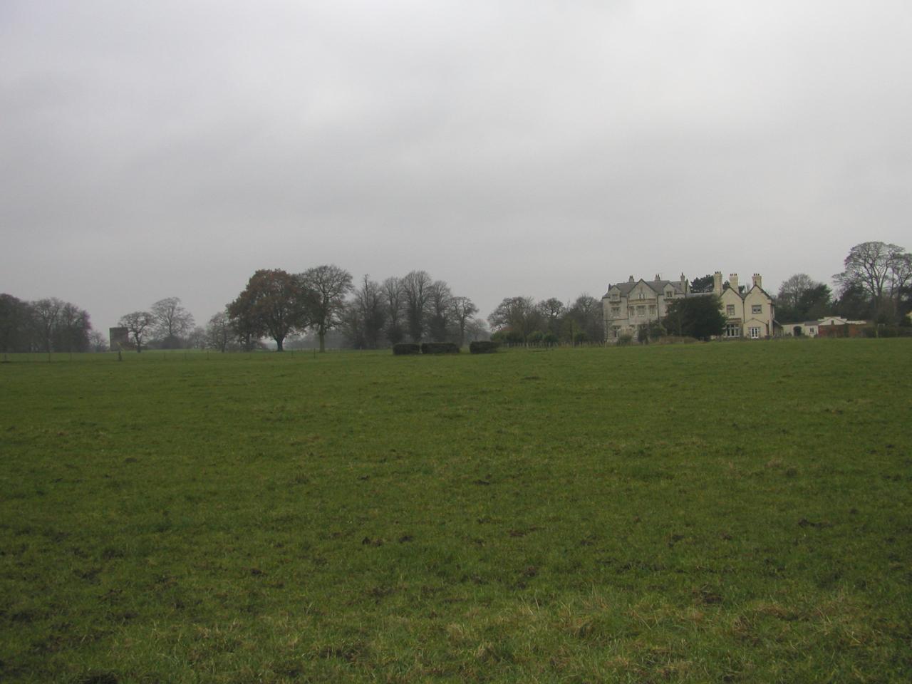 JPEG image - A rather distant shot of Norley Hall with the church visible in the distance to the left ...