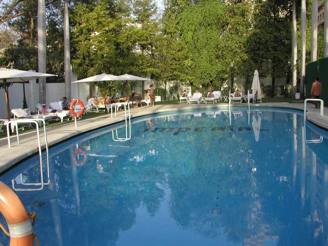 JPEG image - The pool area at the Imperial Hotel. An oasis of peace in the chaos od Delhi. The first morning here I watched monkeys chasing over the wall on the left. ...