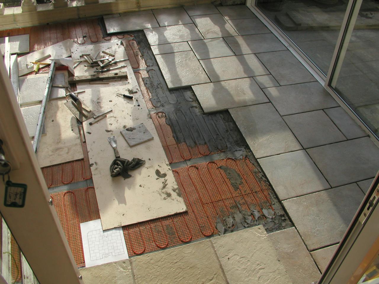 JPEG image - 20th Jan: Another angle on the tiling done so far Thank goodness for computers: in the foreground is a printout of the plan I made to work out a 'random' pattern to fit in with the concrete slabs of the remaining terrace outside. ...